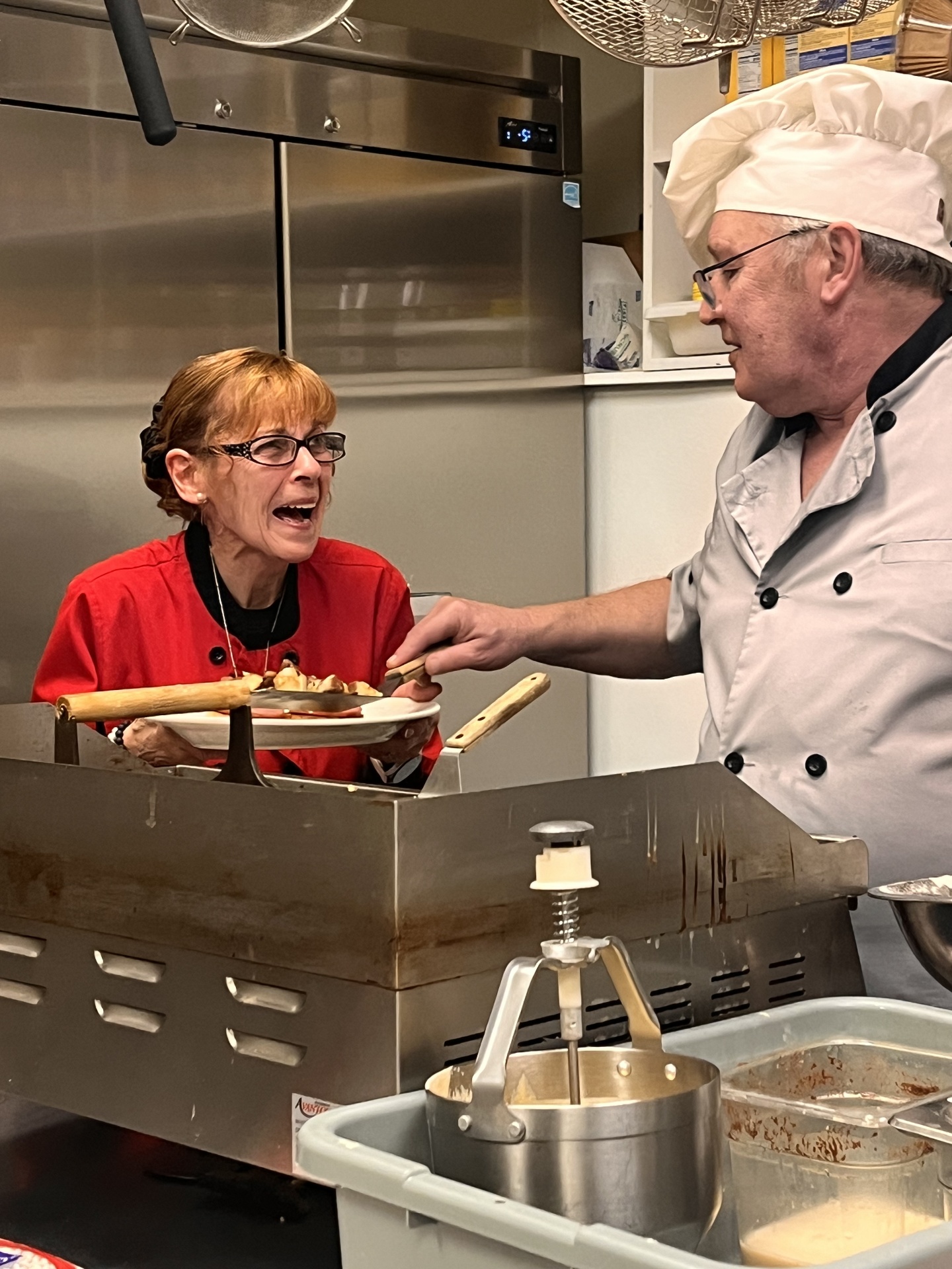 Diana and chef working together in the kitchen
